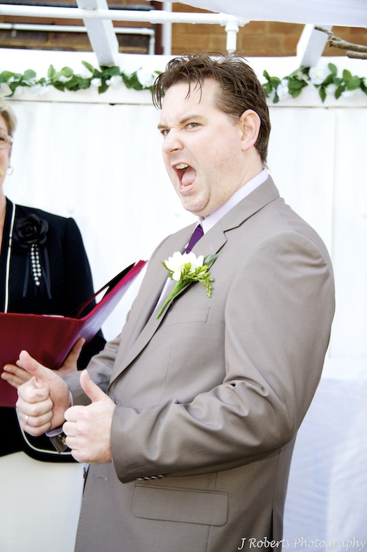 Groom cheering during ceremony - wedding photography sydney